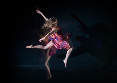a girl in multiple moves of a dance leap with strobe lighting technique
