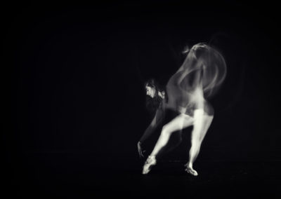black and white image of a girl in multiple moves of a dance move with strobe lighting technique